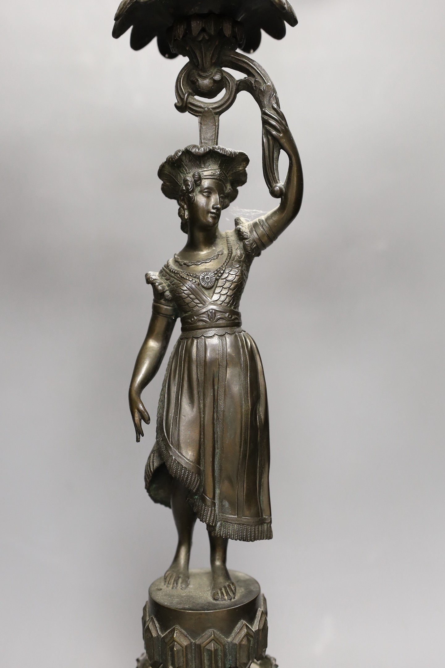 A bronzed spelter figural three light candelabrum, 60cms high